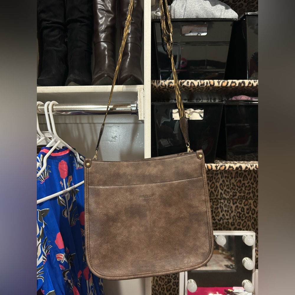 Brown leather crossbody satchel. Comes with a stripped strap also